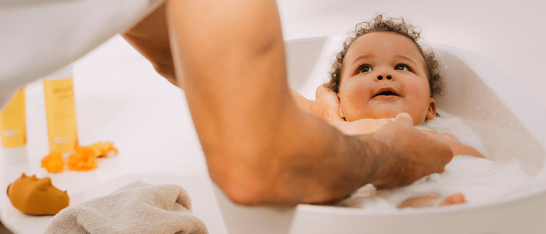 Mujer bañando a un bebé en una bañera