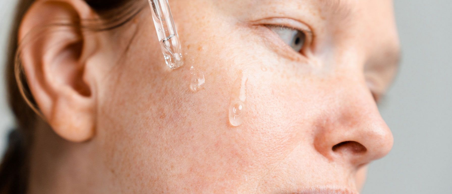 a woman's face with a pipette