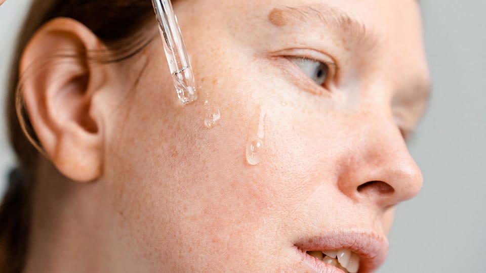 a woman's face with a pipette