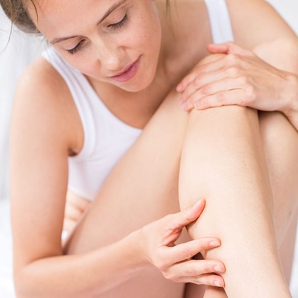 Woman looks at her legs