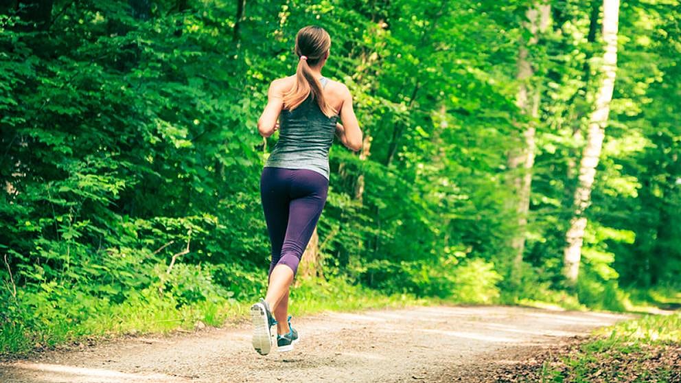 Woman jogging through the forest