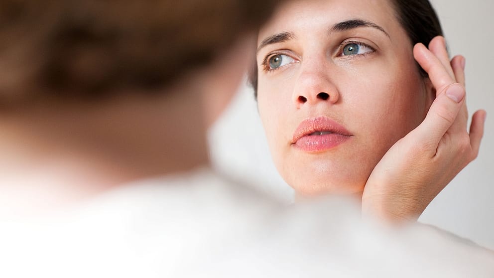 Woman with a hand on her face